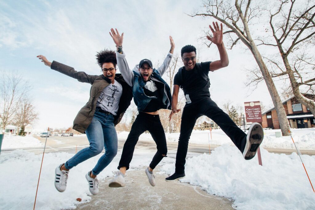 one girl and two guys jumped together